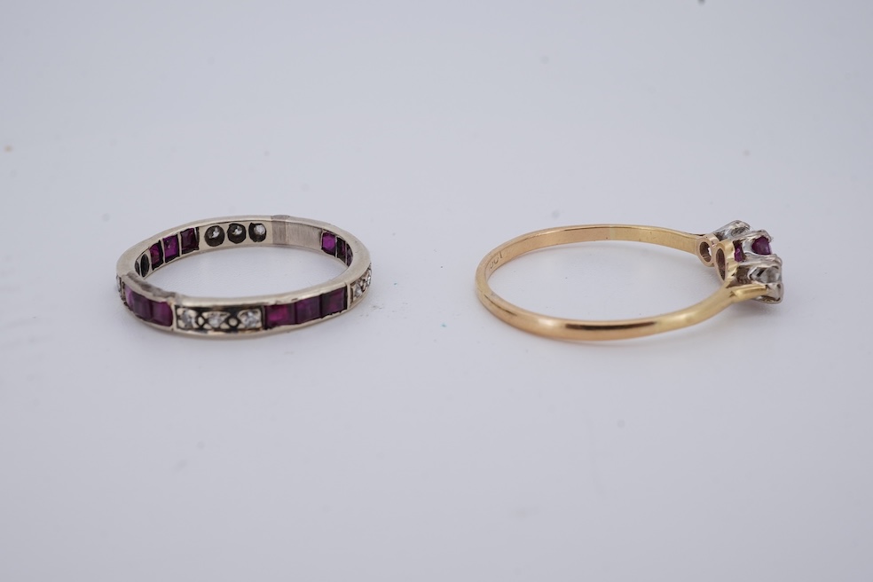 A yellow metal, stamped 18ct, ruby and diamond set three stone ring, size W, together with a yellow metal ruby and diamond set full eternity ring, size Q, gross weight 4.4 grams. Condition - poor to fair